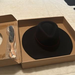 This hat is black felt with a red trim around the top of the hat